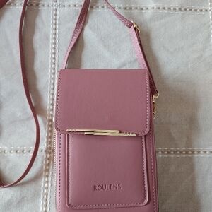 Roulens over shoulder or clutch wallet with cell phone holder.